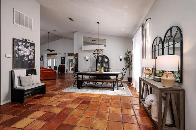 a living room with furniture a ceiling fan and a rug