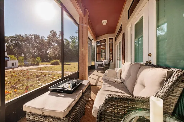 an aerial view of residential houses with outdoor space and trees