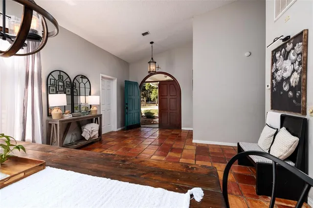 a living room with furniture a rug and a chandelier