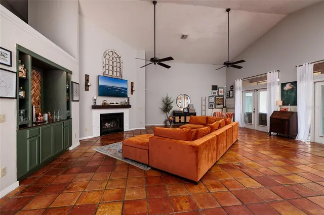 a living room with furniture a clock and a chandelier