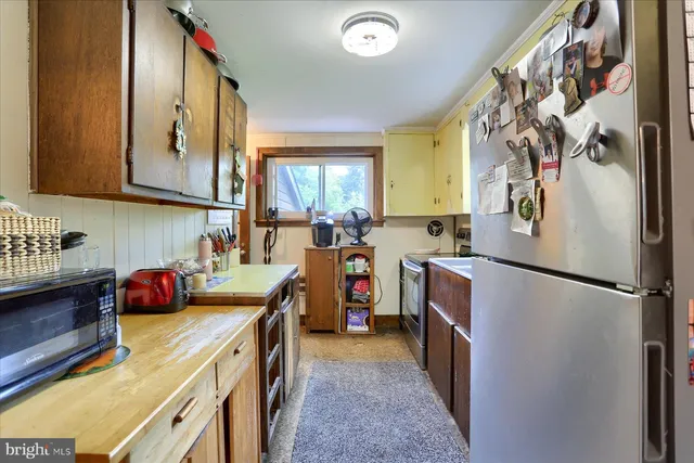 a kitchen with wooden cabinets and a stove top oven