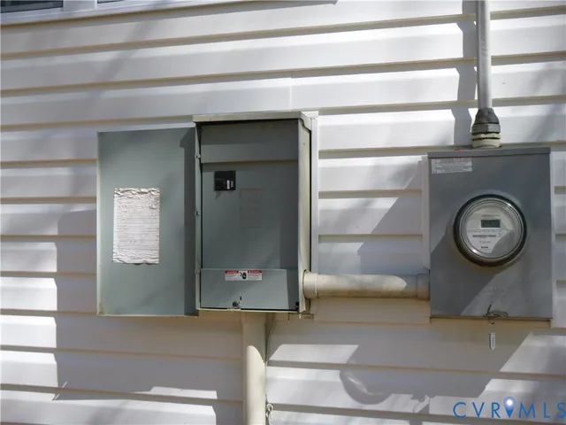 a bathroom with a mirror and a clock on the wall