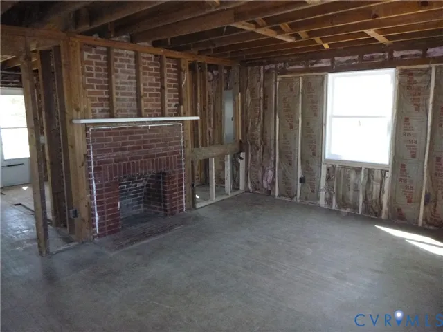 a view of an empty room with a fireplace
