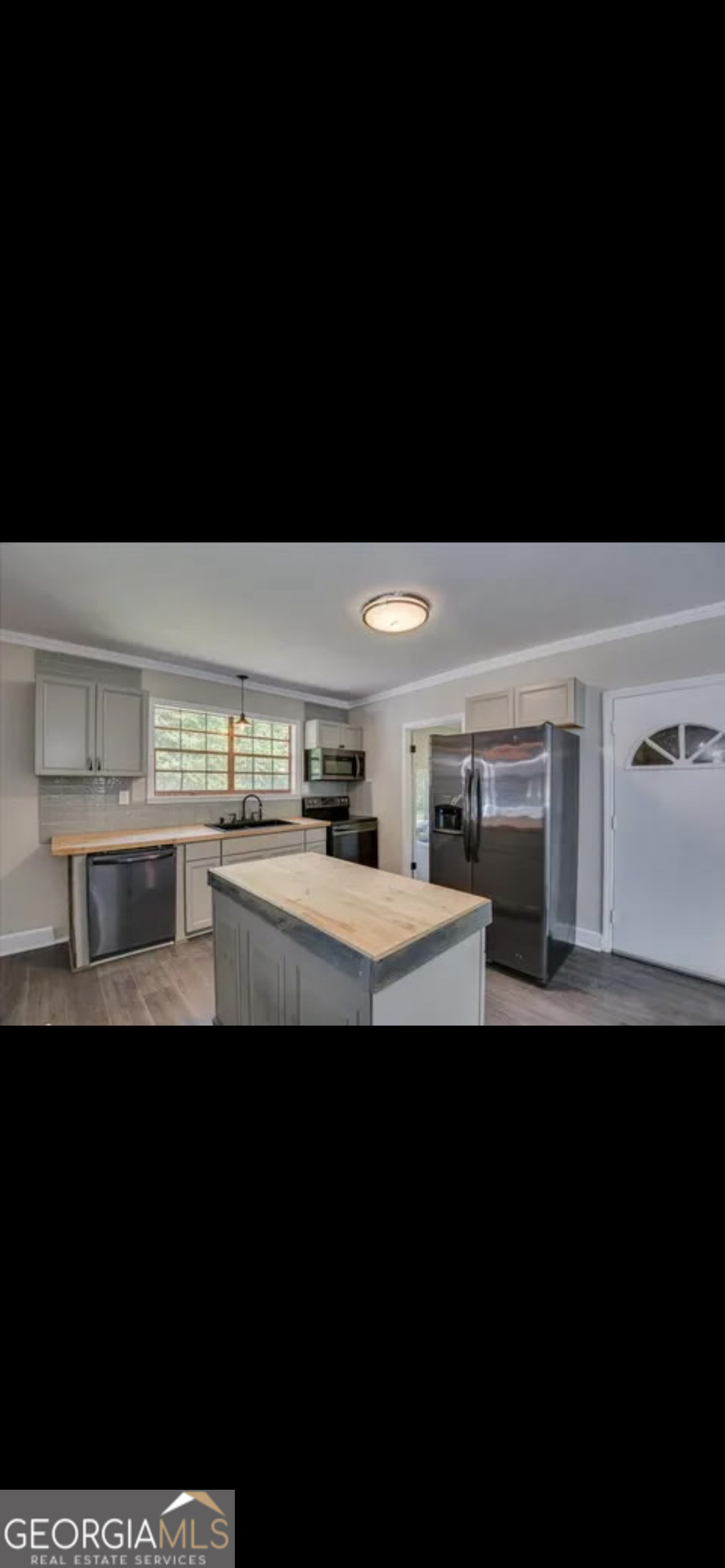 1065 Nathan Jones Road Harlem, GA 30814 - Photo 6 of 32 a kitchen with kitchen island stainless steel appliances a sink and cabinets