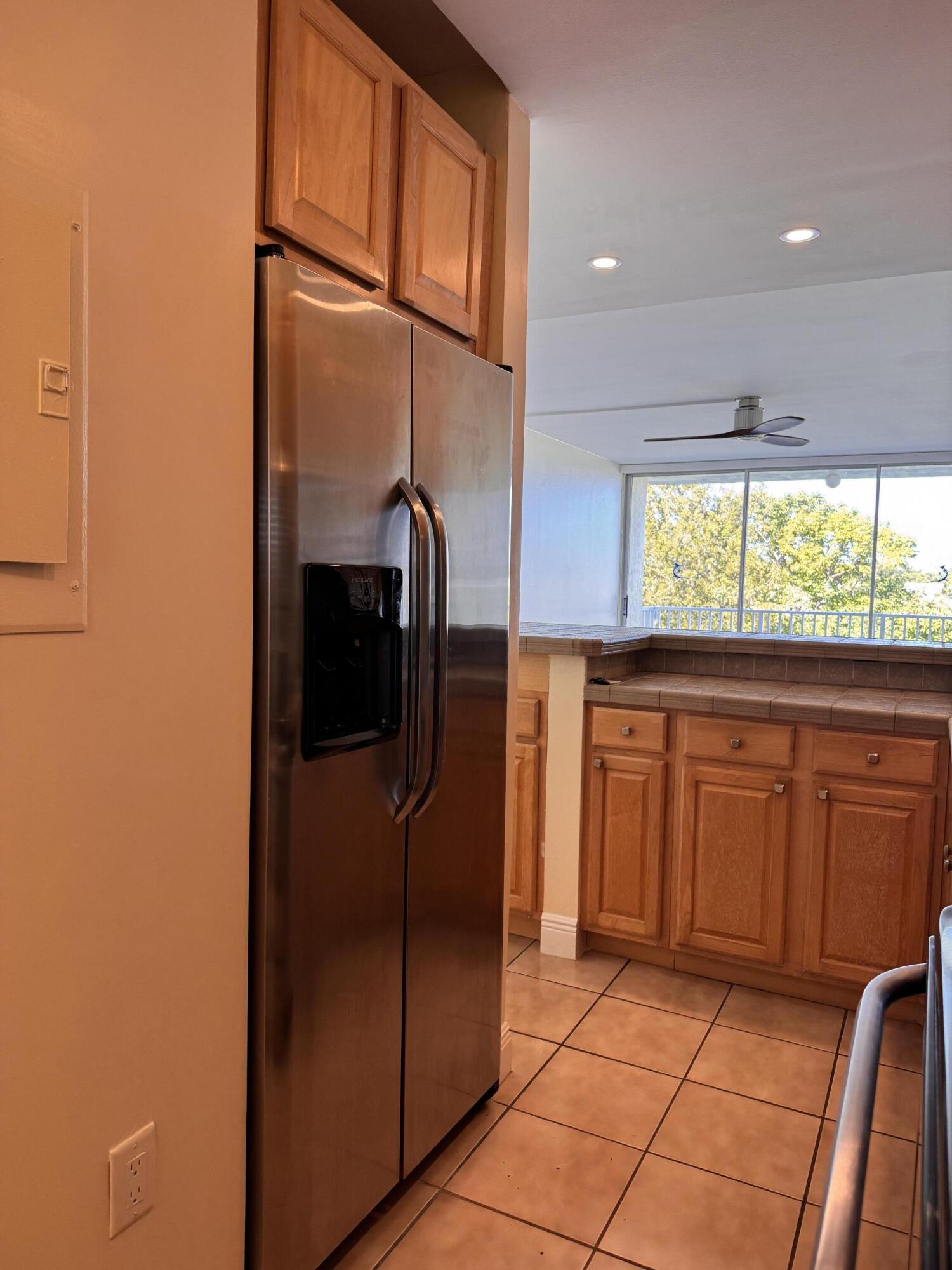 88540 Overseas Highway, Unit 203 Tavernier, FL 33070 - Photo 18 of 35 a kitchen with stainless steel appliances granite countertop a refrigerator and a sink
