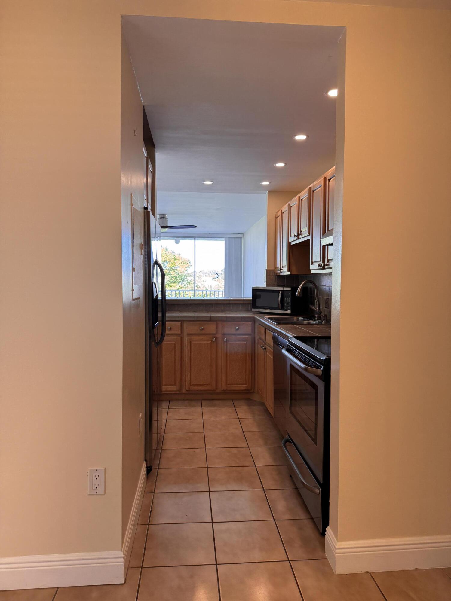 88540 Overseas Highway, Unit 203 Tavernier, FL 33070 - Photo 20 of 35 a kitchen with a sink a counter top space and appliances