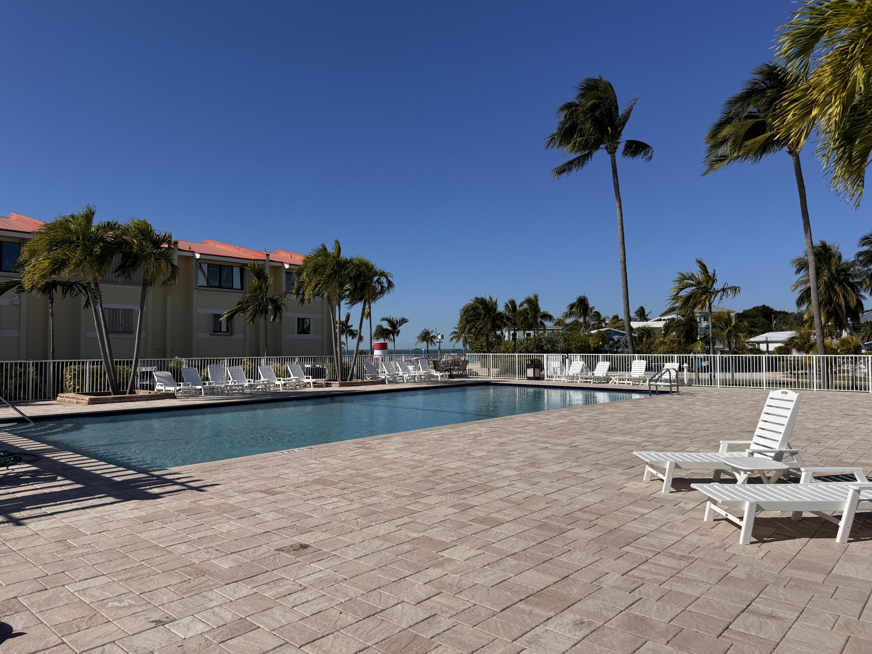 88540 Overseas Highway, Unit 203 Tavernier, FL 33070 - Photo 25 of 35 a view of a terrace with chairs