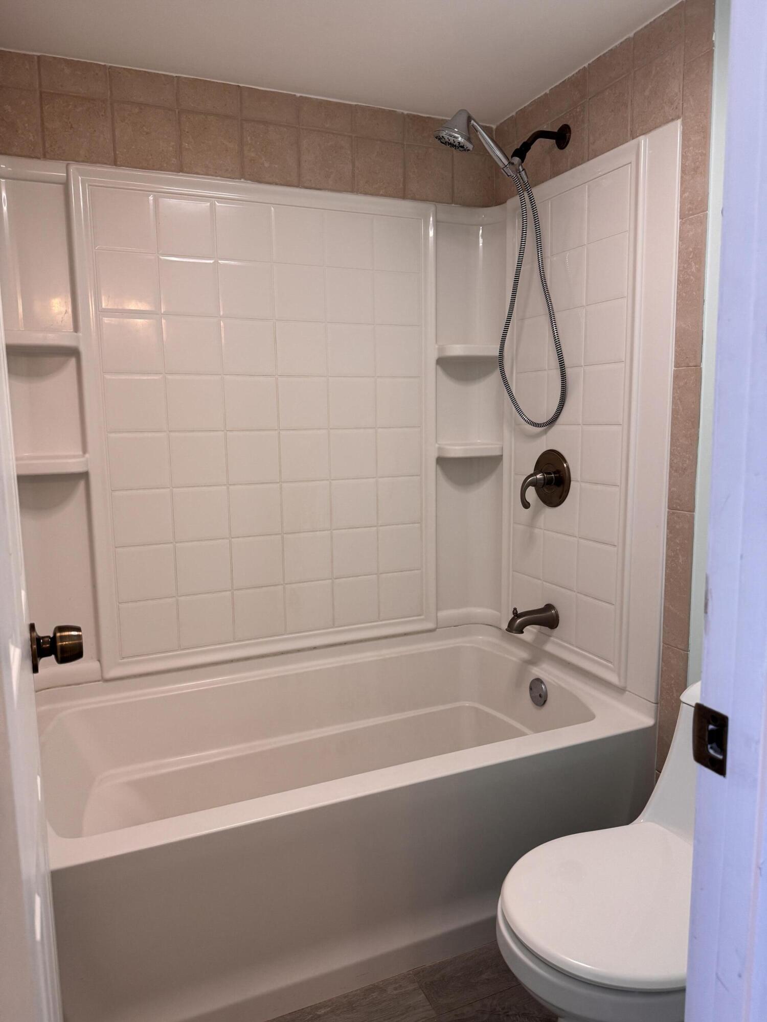 88540 Overseas Highway, Unit 203 Tavernier, FL 33070 - Photo 9 of 35 a bathroom with a toilet and a bath tub