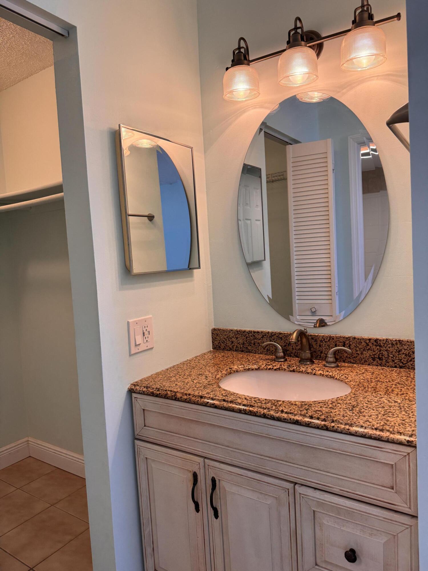 88540 Overseas Highway, Unit 203 Tavernier, FL 33070 - Photo 10 of 35 a bathroom with a sink mirror and vanity