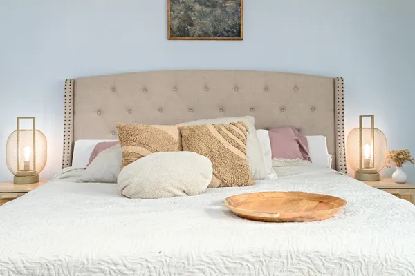 a bedroom with a bed and a lamp