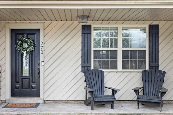 a view of a two chairs in the patio