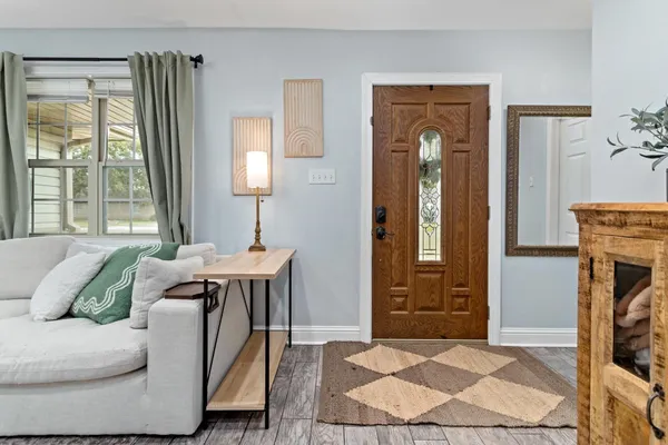 a living room with furniture a fireplace and a window