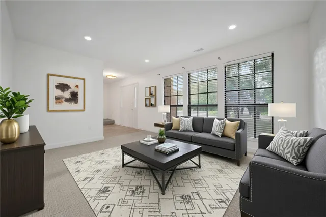 a living room with furniture potted plant and a window