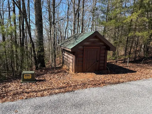 a front view of a house with trees