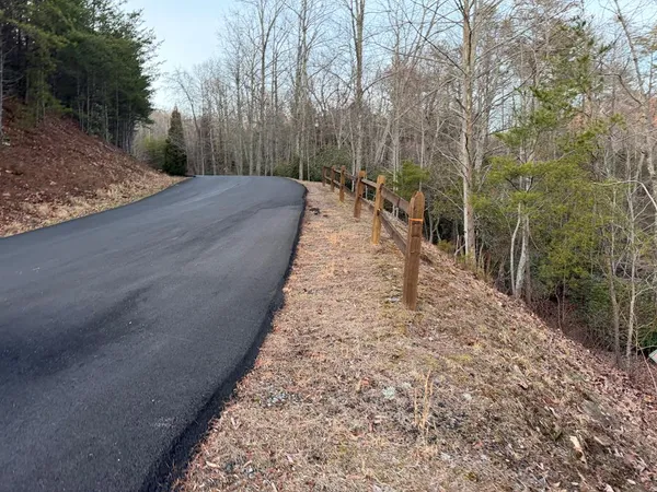a view of a pathway with a wrought fence