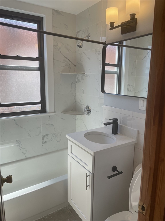 324 Summit Avenue, Unit 3 Boston, MA 02135 - Photo 12 of 16 a bathroom with a sink and mirror with toilet