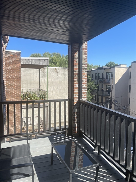 324 Summit Avenue, Unit 3 Boston, MA 02135 - Photo 15 of 16 a view of balcony with wooden floor and fence