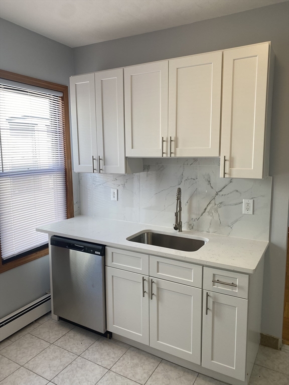 324 Summit Avenue, Unit 3 Boston, MA 02135 - Photo 2 of 16 a kitchen with white cabinets and white appliances