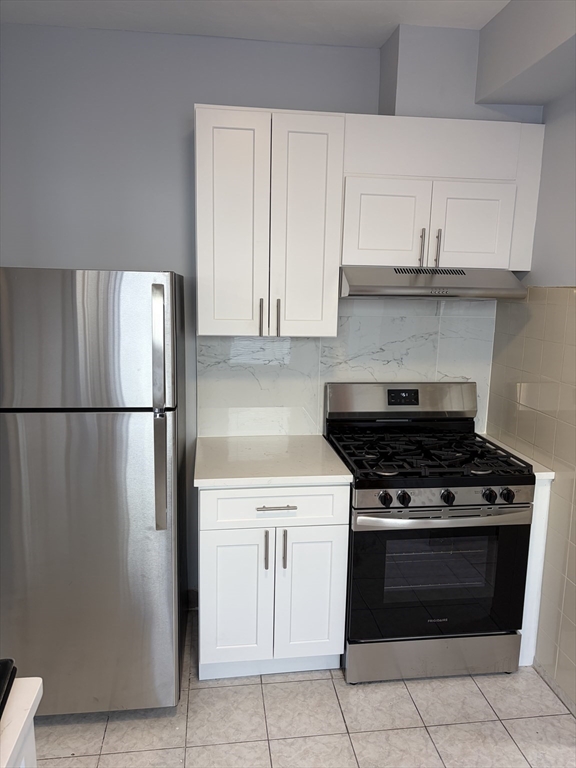 324 Summit Avenue, Unit 3 Boston, MA 02135 - Photo 3 of 16 a stove top oven sitting inside of a kitchen