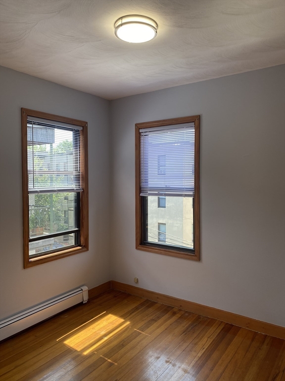 324 Summit Avenue, Unit 3 Boston, MA 02135 - Photo 8 of 16 an empty room with a window