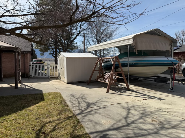415 East Maple Street Mapleton, UT 84664 - Photo 6 of 19 View of patio / terrace featuring a gate, a shed, and a detached carport.