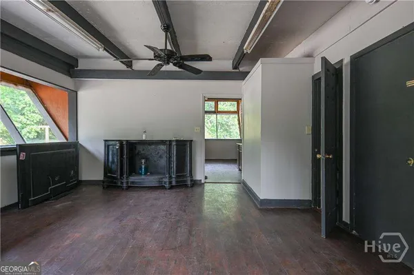 a kitchen with granite countertop a refrigerator and wooden cabinets