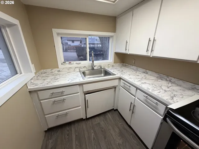 a kitchen with a sink stove and cabinets