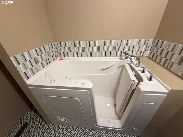 a bathroom with a bathtub and toilet