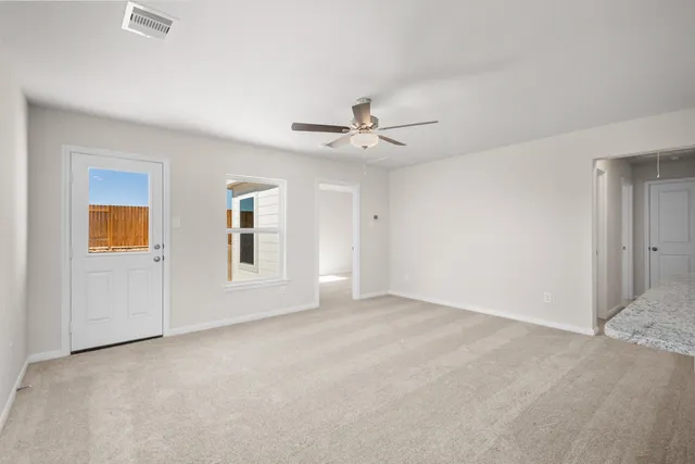 a view of an empty room with a ceiling fan