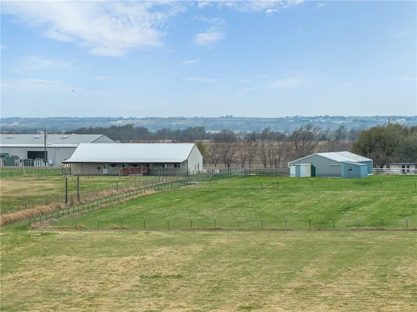 an aerial view of a house with big yard
