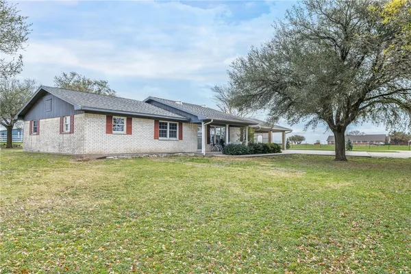 a front view of house with yard and green space