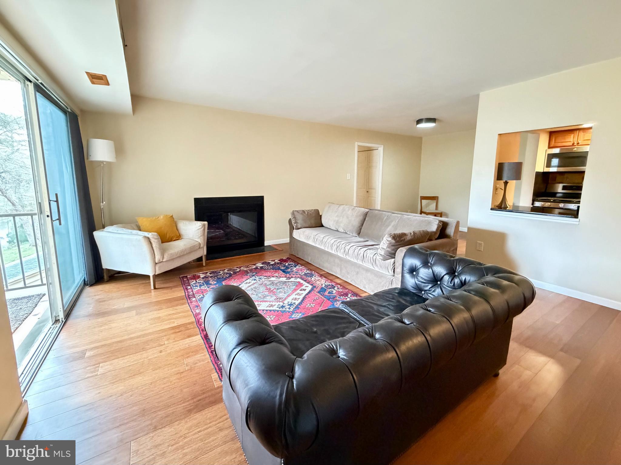 513 Old Forge Crossing, Unit 513 Wayne, PA 19087 - Photo 3 of 22 Living Room w/ Fireplace & Open to Dining Area