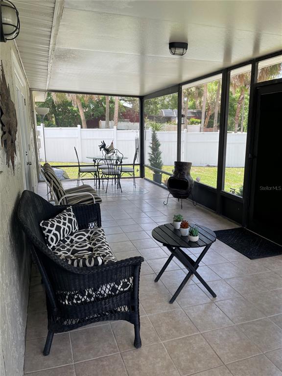575 Tiberon Cove Road Longwood, FL 32750 - Photo 56 of 56 a living room with furniture and a floor to ceiling window