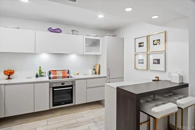 a kitchen with a sink appliances and cabinets
