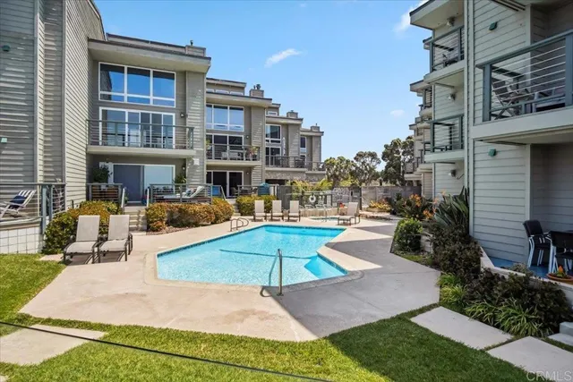 a view of a swimming pool with outdoor seating