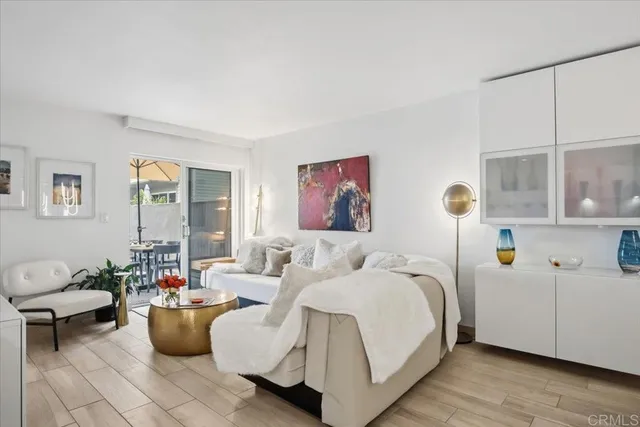 a living room with furniture and kitchen view