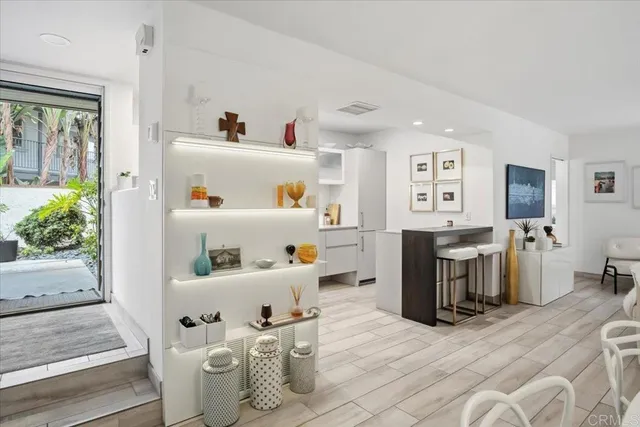 a kitchen with granite countertop a sink cabinets and stainless steel appliances