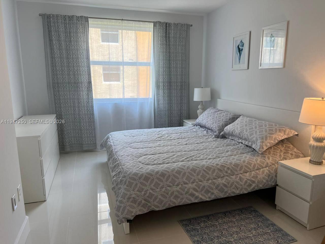 17100 North Bay Road, Unit 1509 Sunny Isles Beach, FL 33160 - Photo 13 of 21 a bedroom with a bed and a window