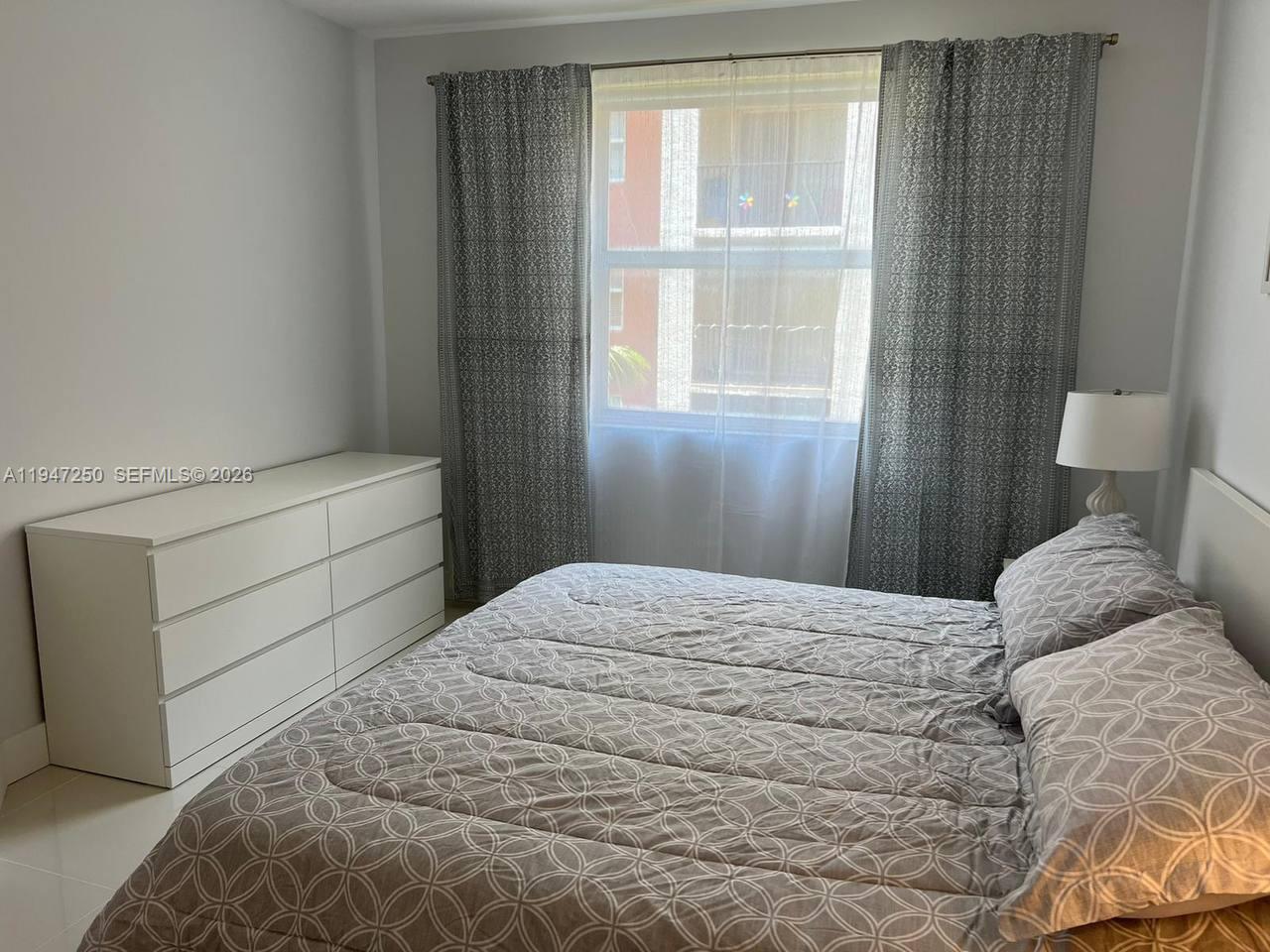 17100 North Bay Road, Unit 1509 Sunny Isles Beach, FL 33160 - Photo 14 of 21 a bedroom with a bed and a window