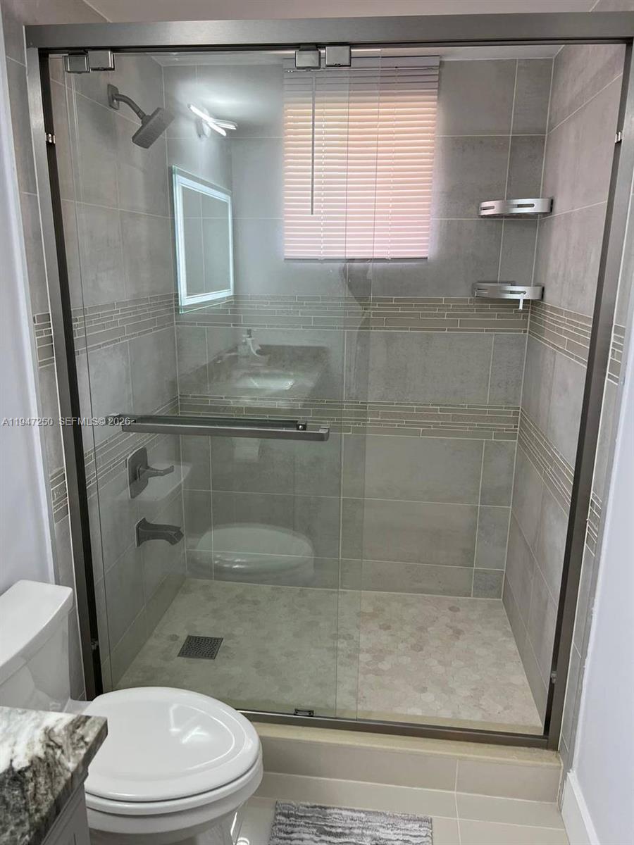 17100 North Bay Road, Unit 1509 Sunny Isles Beach, FL 33160 - Photo 17 of 21 a bathroom with a shower a toilet and a sink