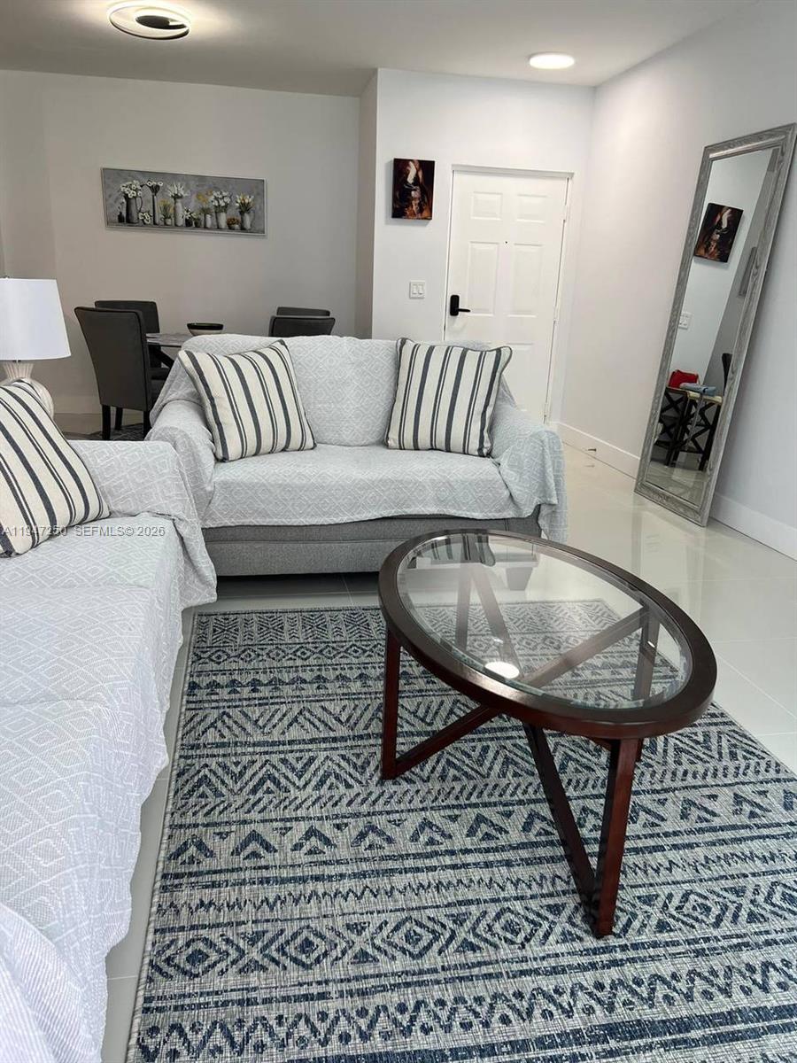17100 North Bay Road, Unit 1509 Sunny Isles Beach, FL 33160 - Photo 4 of 21 a living room with furniture and a rug