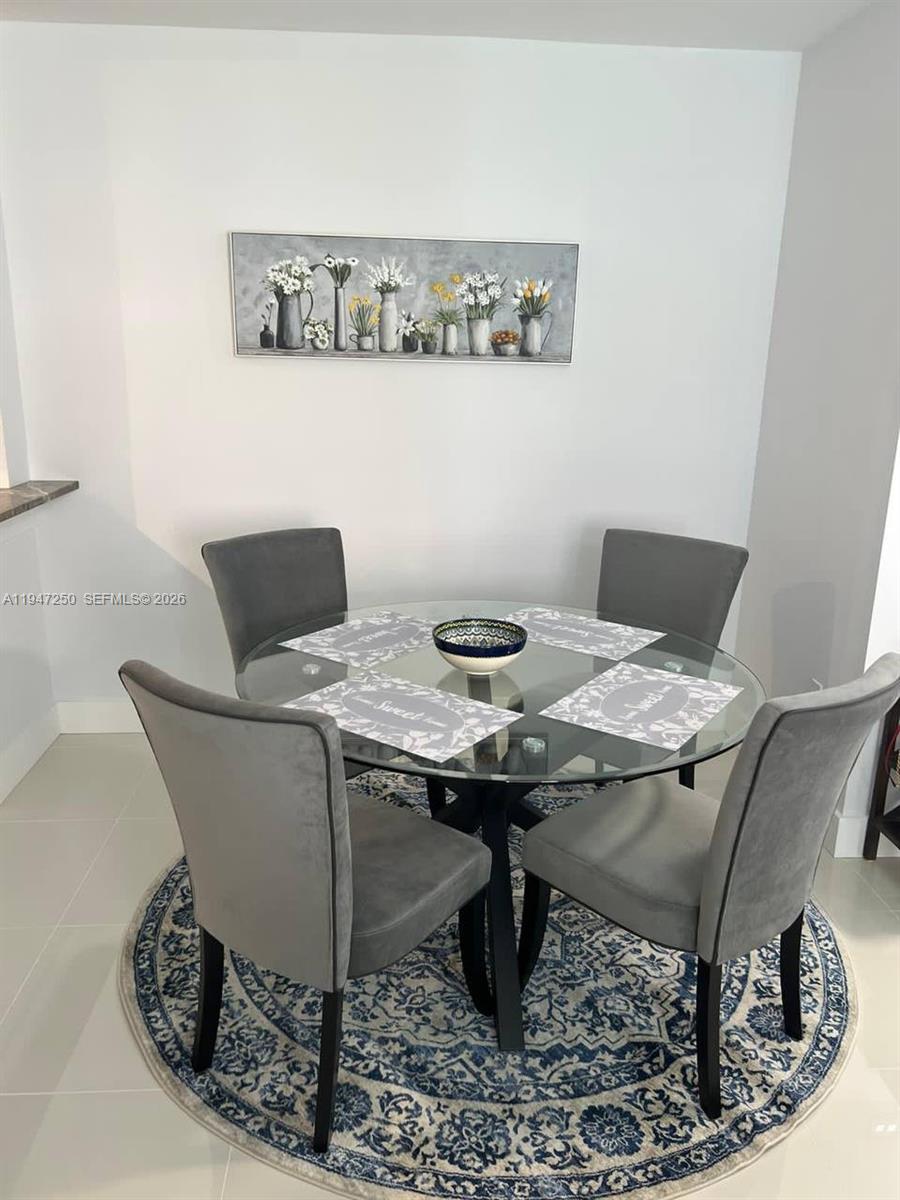 17100 North Bay Road, Unit 1509 Sunny Isles Beach, FL 33160 - Photo 7 of 21 a view of a dining room with furniture
