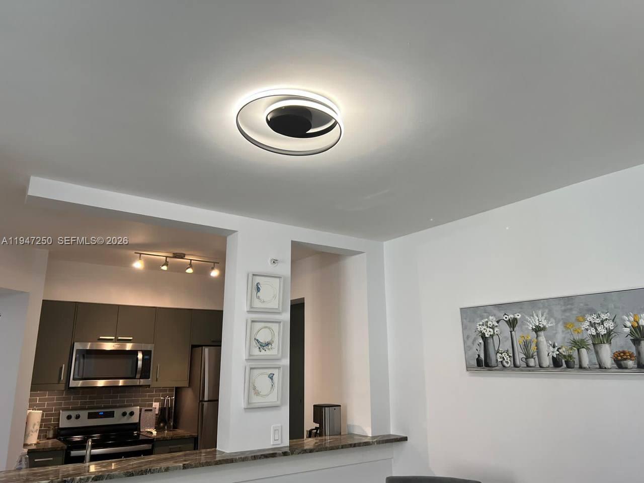 17100 North Bay Road, Unit 1509 Sunny Isles Beach, FL 33160 - Photo 8 of 21 a view of a room with furniture and a flat screen tv