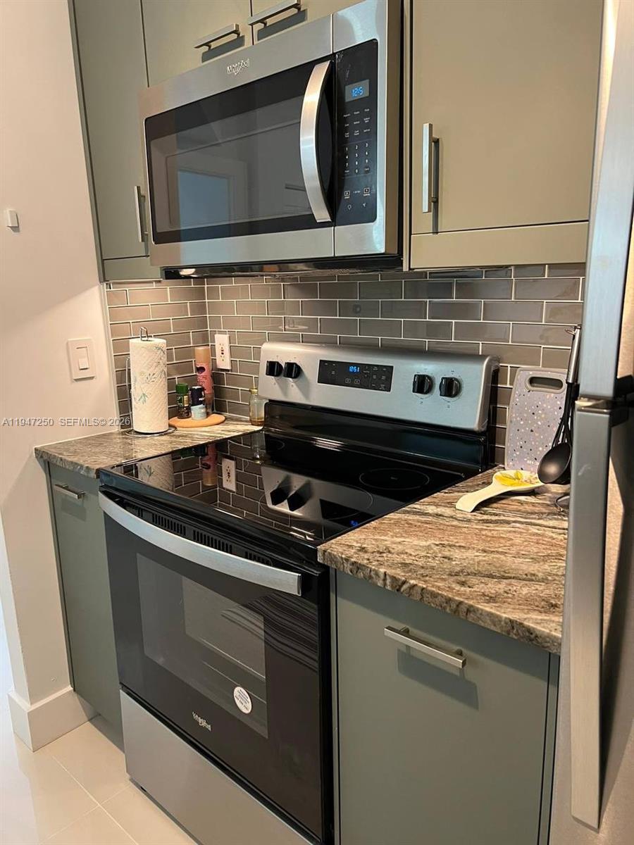 17100 North Bay Road, Unit 1509 Sunny Isles Beach, FL 33160 - Photo 10 of 21 a stove top oven sitting inside of a kitchen