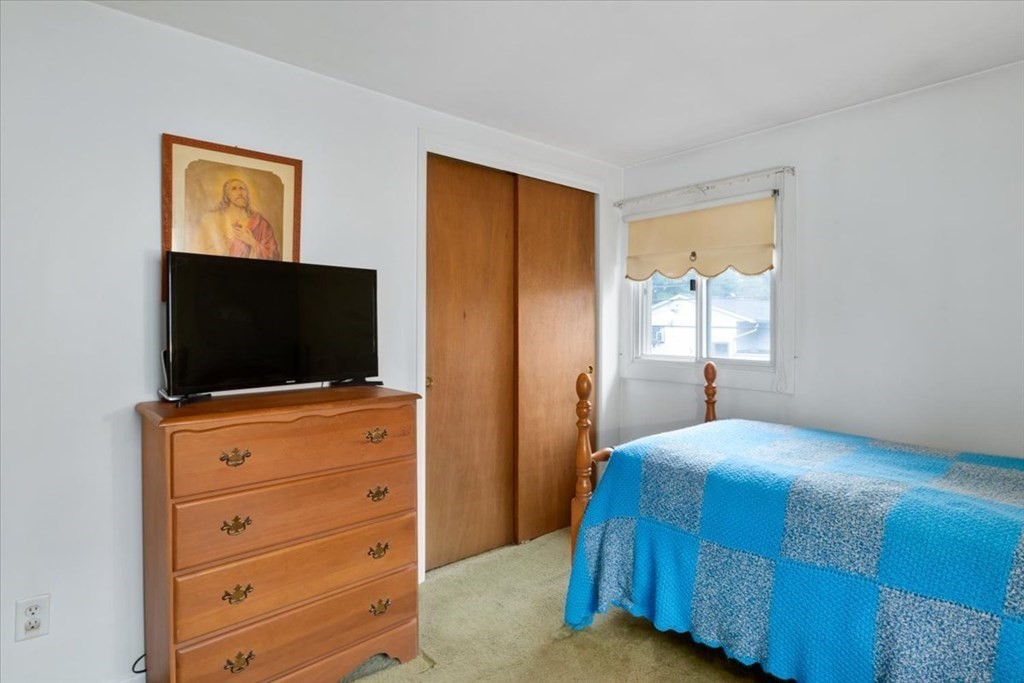 9 Belnap Road Boston, MA 02136 - Photo 23 of 35 a bedroom with a bed and a flat screen tv