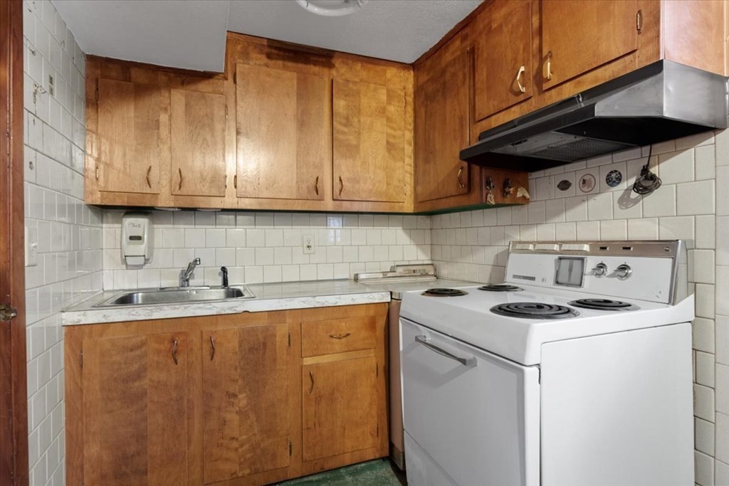 9 Belnap Road Boston, MA 02136 - Photo 28 of 35 a kitchen with a sink a stove and cabinets