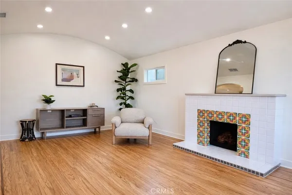 a bedroom with furniture and a wooden floor