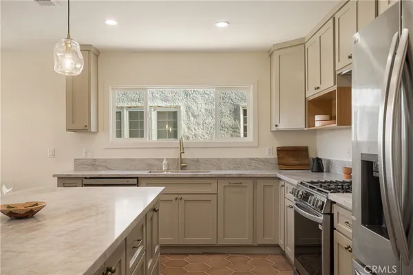 a kitchen with kitchen island a dining table and wooden floor