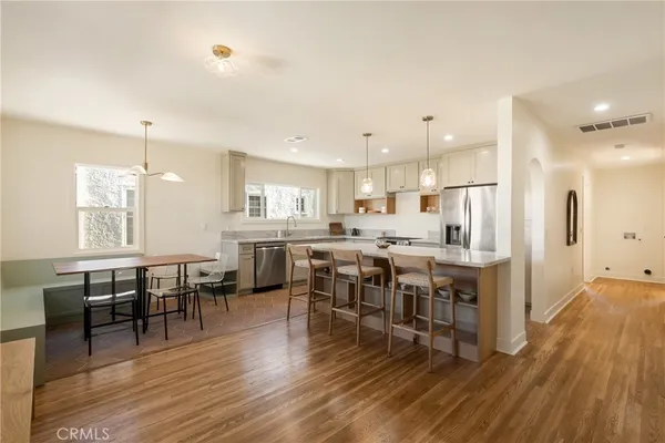 a kitchen that has a cabinets a sink and appliances