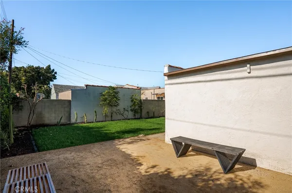a backyard of a house with table and chairs